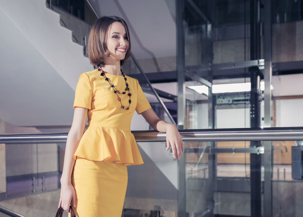 Young,Fashion,Business,Woman,Leaning,On,Railing,At,Office,Stylish