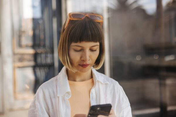 Close,Up,Focused,Young,Caucasian,Woman,Typing,Text,On,Phone