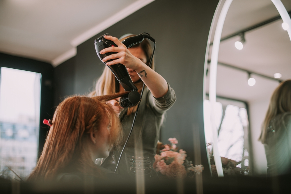 Close,Up,Of,Hairdresser,Blow,Drying,Her,Clients,Bangs,While