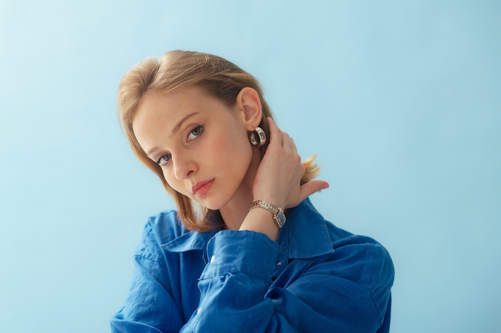 Young,Beautiful,Woman,With,Healthy,Freckled,Skin,Wearing,Silver,Hoop