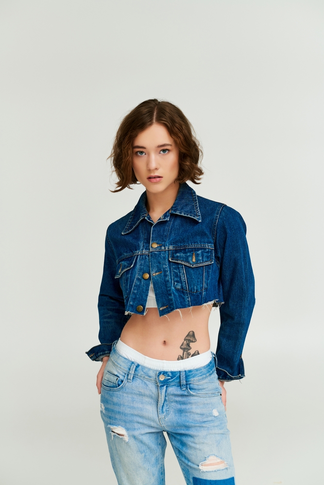 Stylish,Young,Woman,With,Tattoo,Posing,In,Cropped,Denim,Jacket