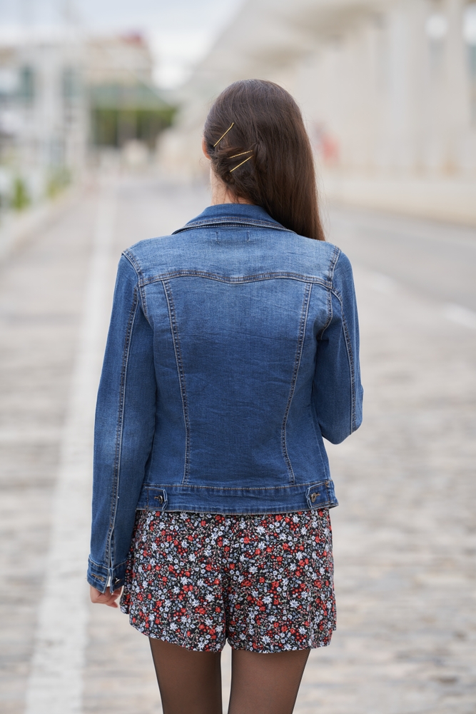 Young,Woman,Walking,On,A,City,Street,,Viewed,From,Behind,