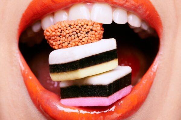 Closeup,,Lipstick,And,Woman,With,Candy,In,Mouth,,Makeup,And