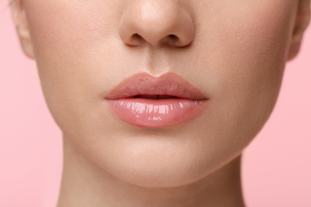 Woman,Wearing,Beautiful,Lip,Gloss,On,Pink,Background,,Closeup