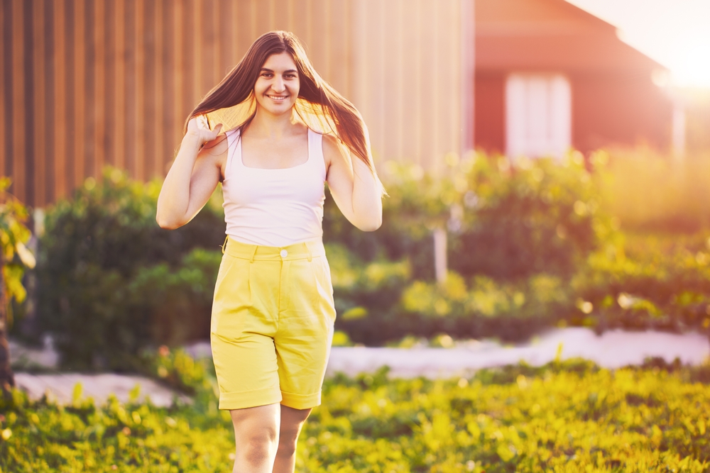 Portrait,Of,European,Woman,In,Her,20s,Wearing,Bermuda,Shorts