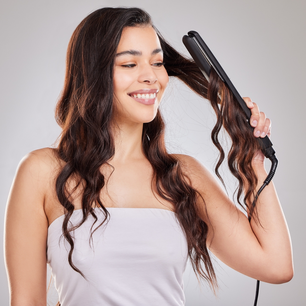 Flat,Iron,,Hair,Care,And,Woman,With,Curls,In,Studio