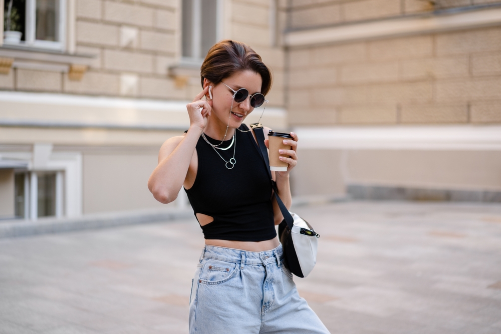 Stylish,Woman,With,Short,Haircut,Walking,In,Street,With,Coffee jeans