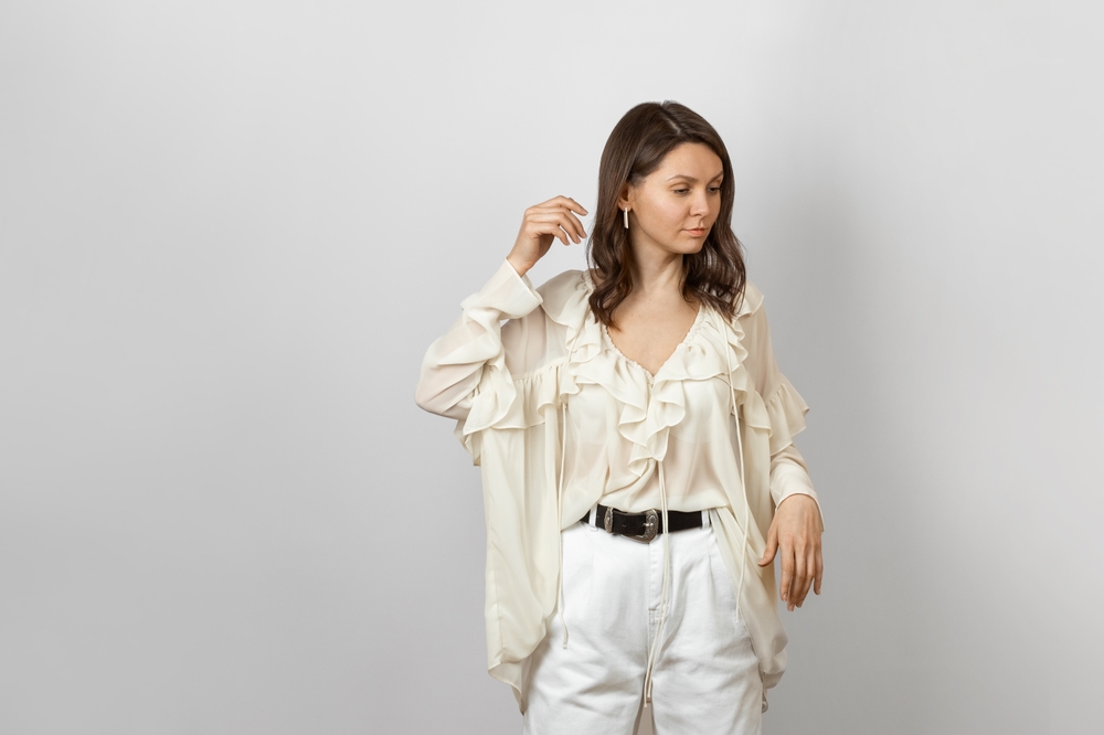 A,Stylish,Woman,In,A,White,Ruffled,Blouse,And,White