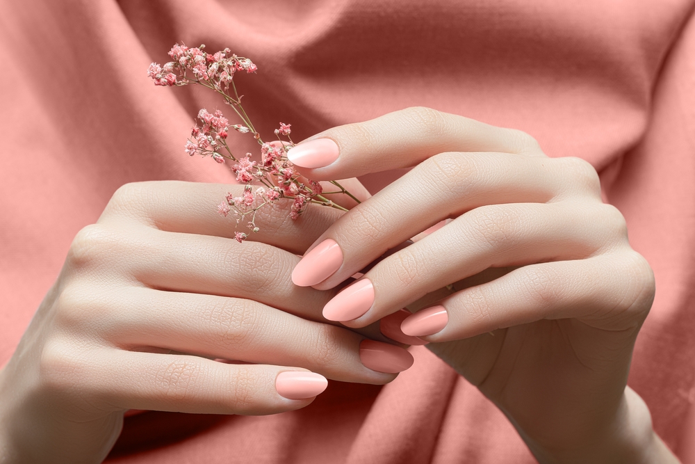 Female,Hands,With,Peach,Color,Nail,Design.,Female,Hands,Holding