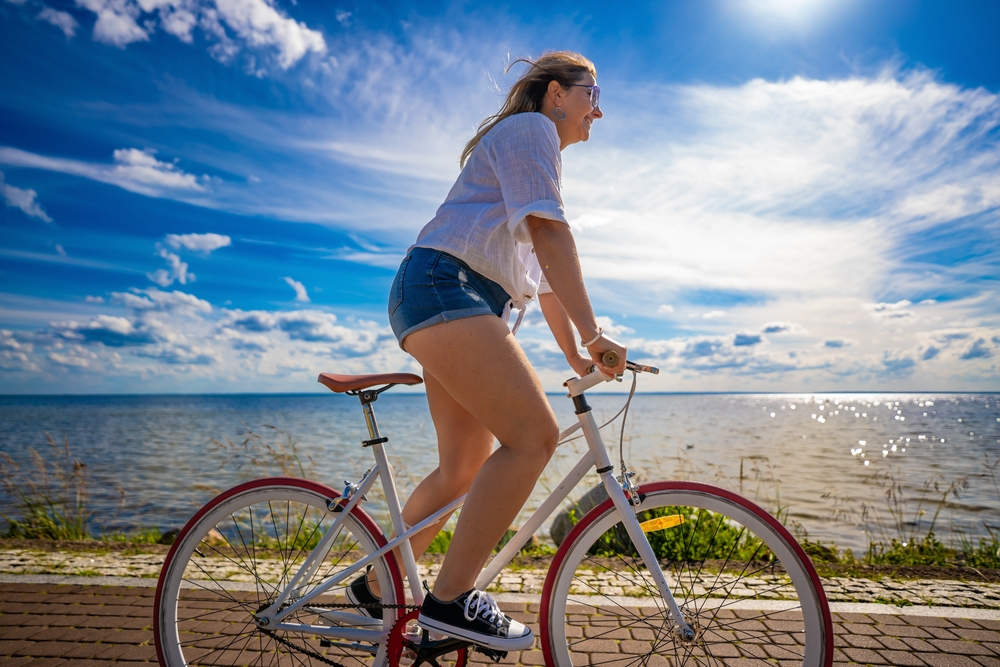 Summer,Vacation,By,Bike.,Young,Energetic,Woman,With,Long,Hair, shorts