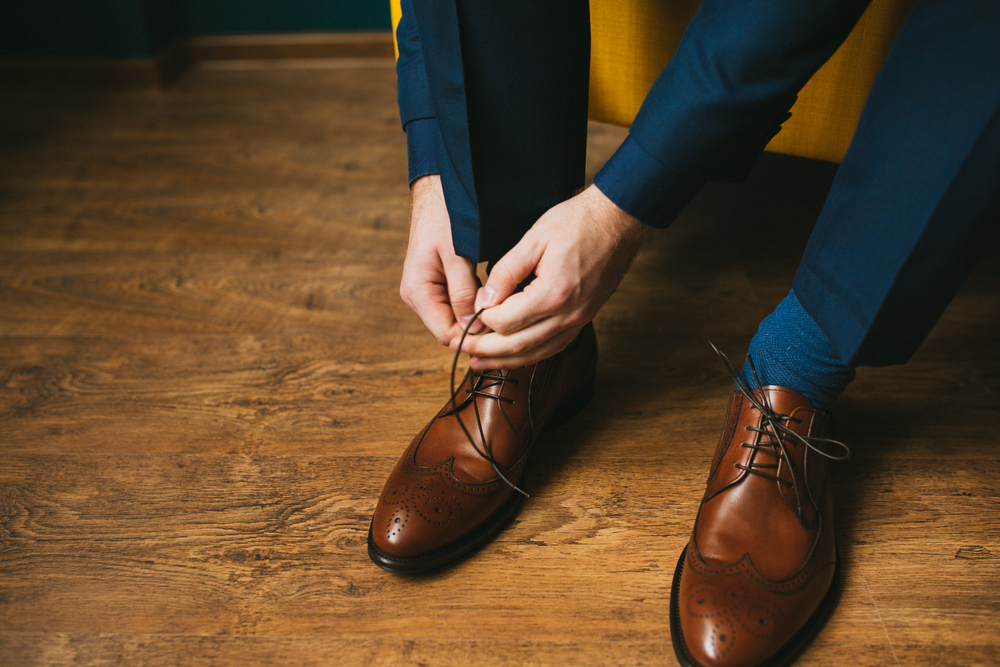 A,Man,In,A,Blue,Suit,Ties,Up,Shoelaces,On