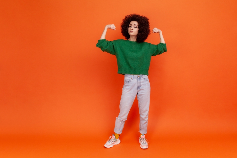 Full,Length,Portrait,Of,Woman,With,Afro,Hairstyle,In,Green