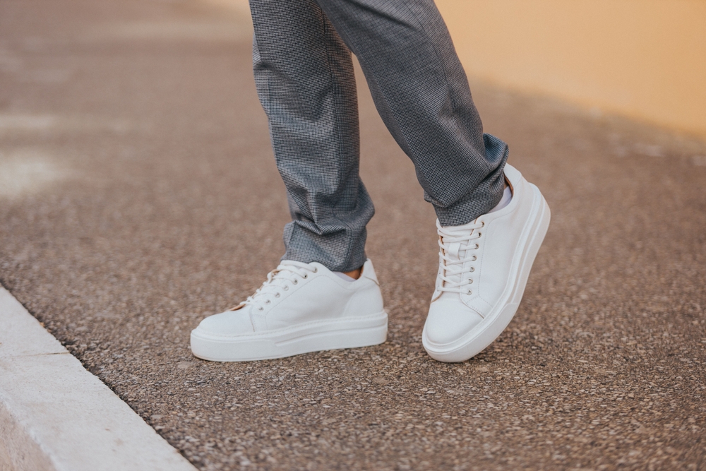 A,Close-up,Shot,Of,A,Man,Wearing,White,Sneakers,With